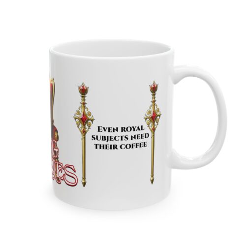 King Charles Royal Coffee Mug featuring a regal Cavalier King Charles Spaniel on a desk with a notebook and pen.